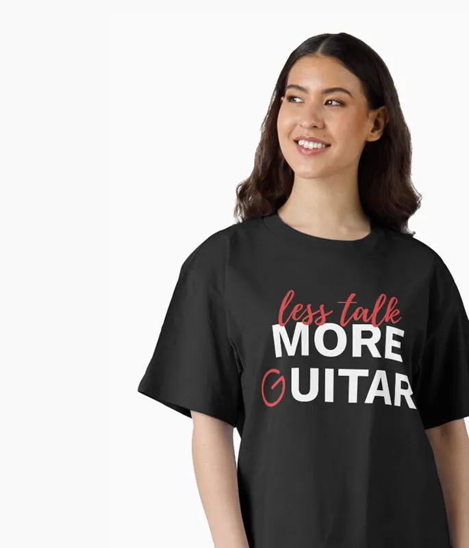 Female model wearing a T-shirt with the words "Less Talk. More Guitar" on it.