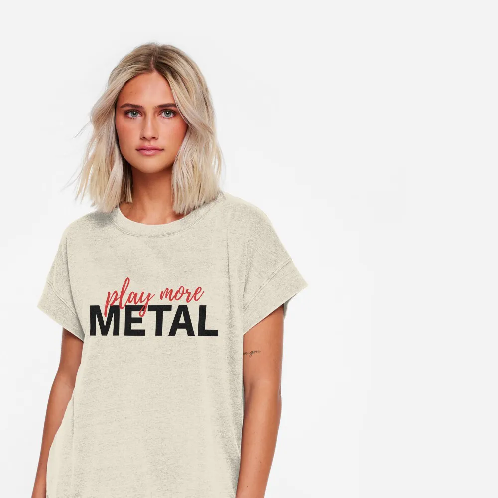 Female model wearing a light coloured shirt that says "Play More Metal".